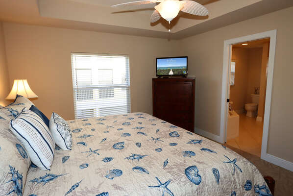 Master Bedroom with king bed and smart TV entry into master bathroom