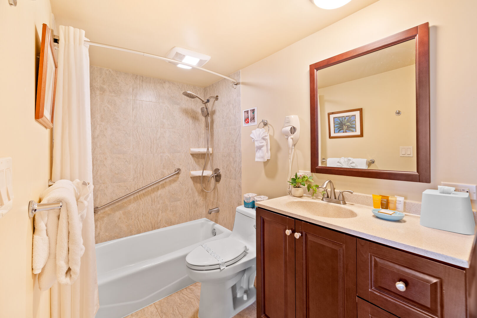 The bathroom has a vanity with a cabinet and a shower/tub combination!