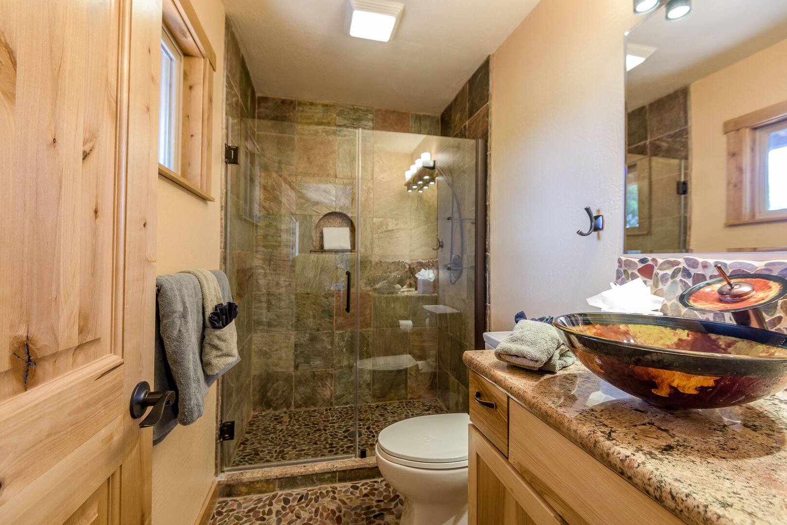 En Suite Bath with Unique Stonework and a Tile/Glass Shower