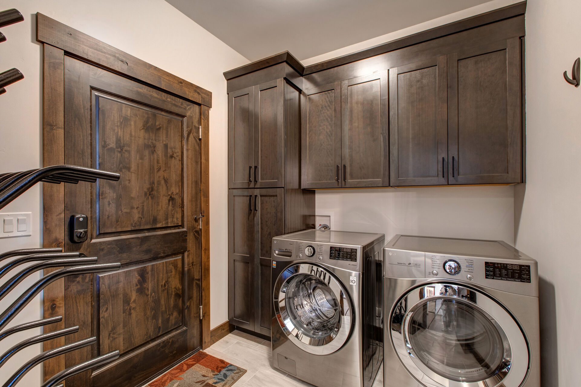 Large private laundry room off kitchen with brand new, full sized LG washer and dryer units, as well as key-padded entrance from the homes' private garage, outfitted with a ski/snowboard boot drying rack