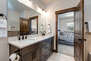 Master Bathroom with large tiled shower which also serves as a steam shower, separate soaking bathtub, and dual vanities