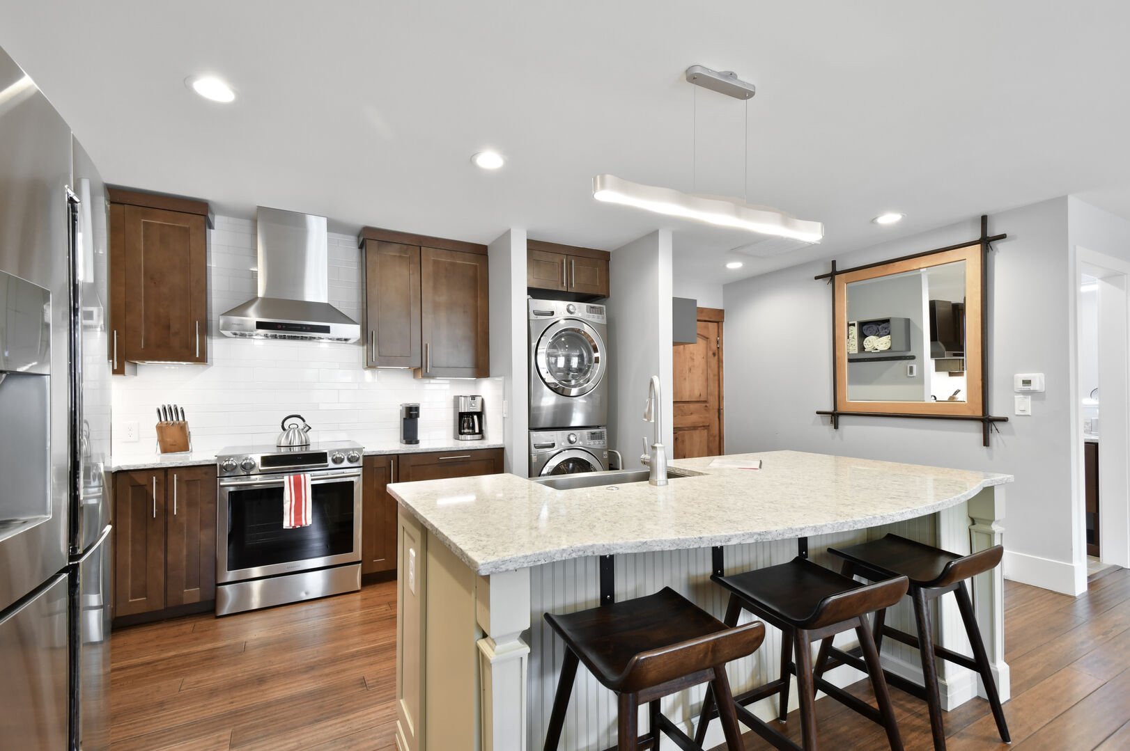 Luxurious kitchen with granite counter tops and stainless steel appliances.