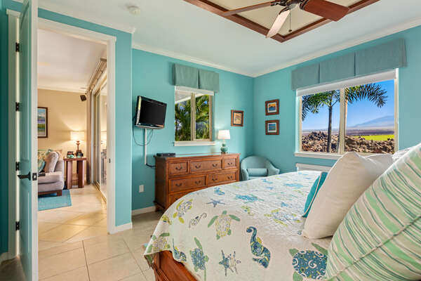Primary Bedroom with Ocean Themed Decor and TV at Mauna Lani Hawai'i Vacation Rental