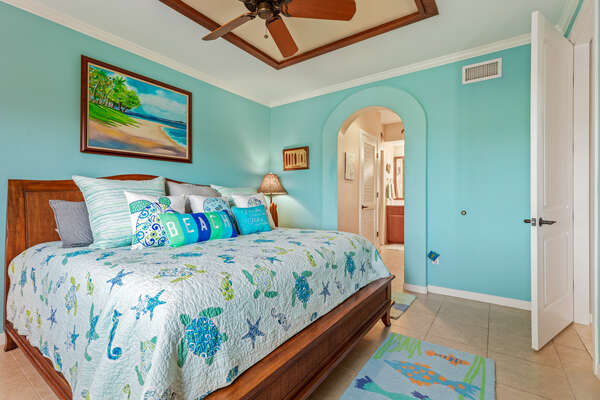 King Bed with Sea Themed Linens and Connected Bathroom