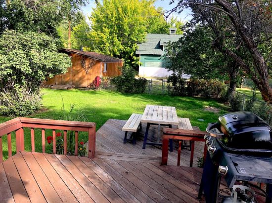 Backyard deck with gas grill and fully fenced yard