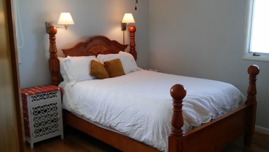 Bedroom 1 features queen bed with mountain views & en suite bath