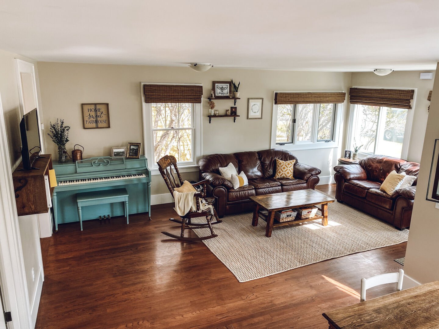 Cozy living area with plenty of natural light and beautifully restored hardwood floors