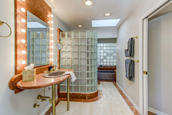 Private Master Bath 1 with a Marble Counter Vanity and Walk-in Closet