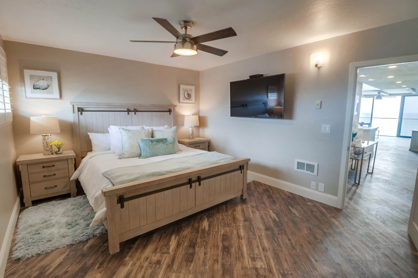 Master bedroom with dresser, 55 inch Smart TV, ceiling fan and king size bed