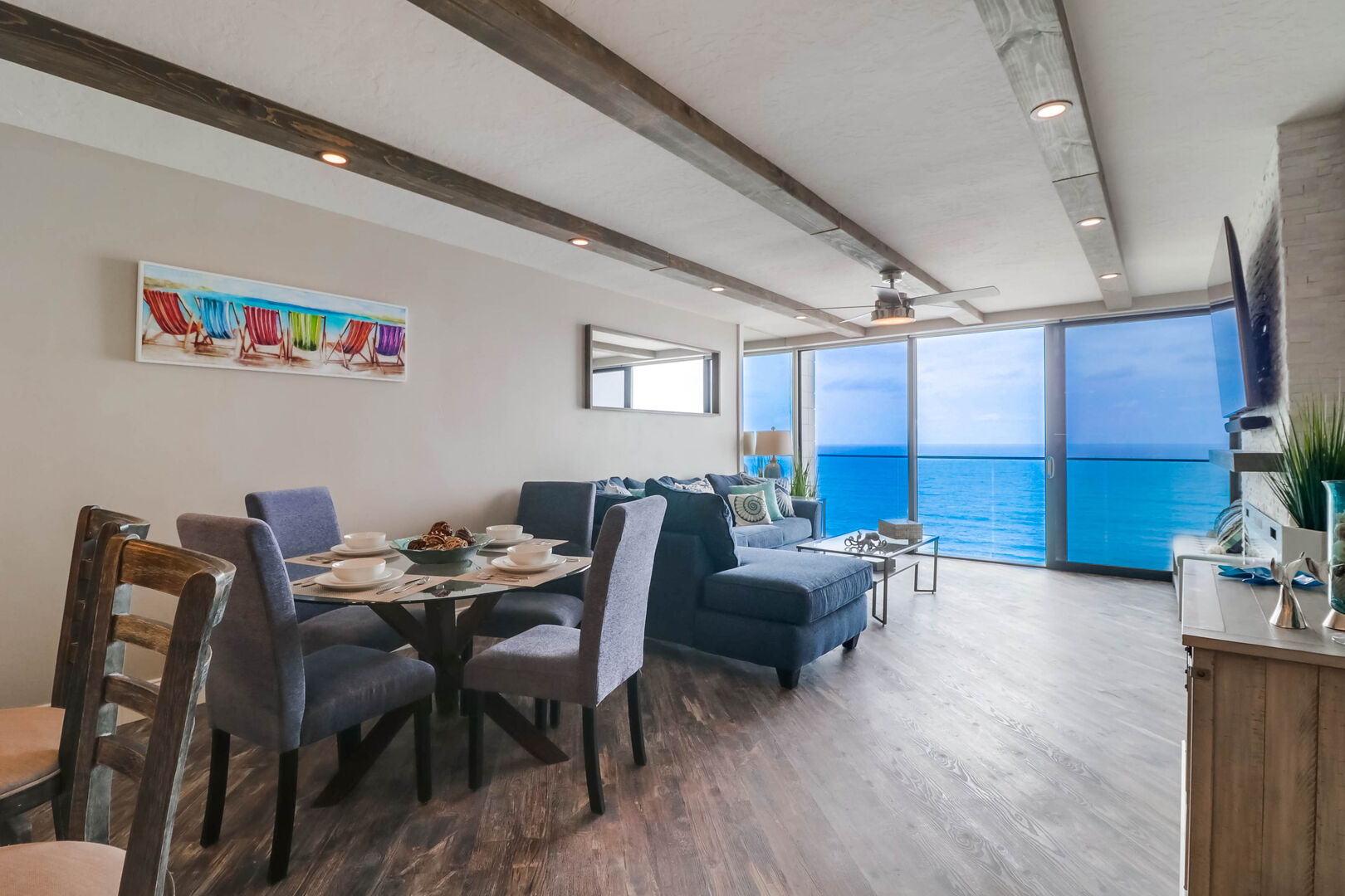 Open floor plan with dining area for 4, living room, kitchen and ocean views