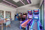 Communal Game Room with a Skee Ball, Video Games, a Pool Table and Shuffleboard Table
