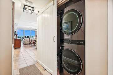 LG full size washer and dryer in unit with sliding barn door