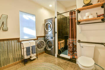 Bathroom with Laundry Set, Shower, and Toilet.