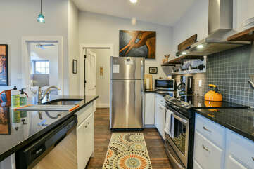 Entire kitchen with fridge, island, sink, stove, and microwave