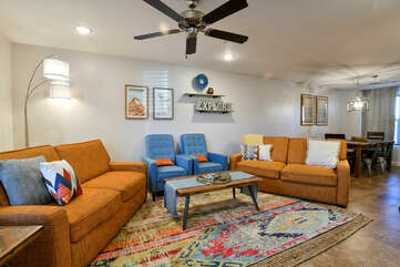 Sofas, Arm Chairs, Coffee Table, Floor Lamp, and Ceiling Fan.