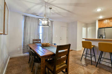 Dining Table, Chairs, Window, Kitchen Bar, Stools, and Pendant Lamp.