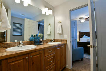Double Vanity Sink, Shower, Mirror, and Lamps.
