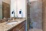 Master Bathroom with jack-n-jill access from Main Living Area, stone countertops, and large tiled shower