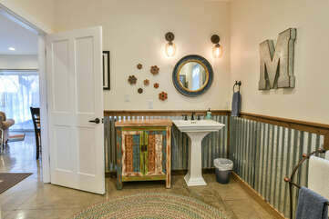 Pedestal Sink, Mirror, and Wall Lamps.