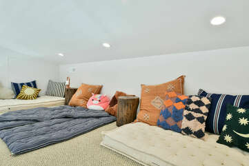 The Loft with Twin Mattresses, Pillows, and Nightstands.