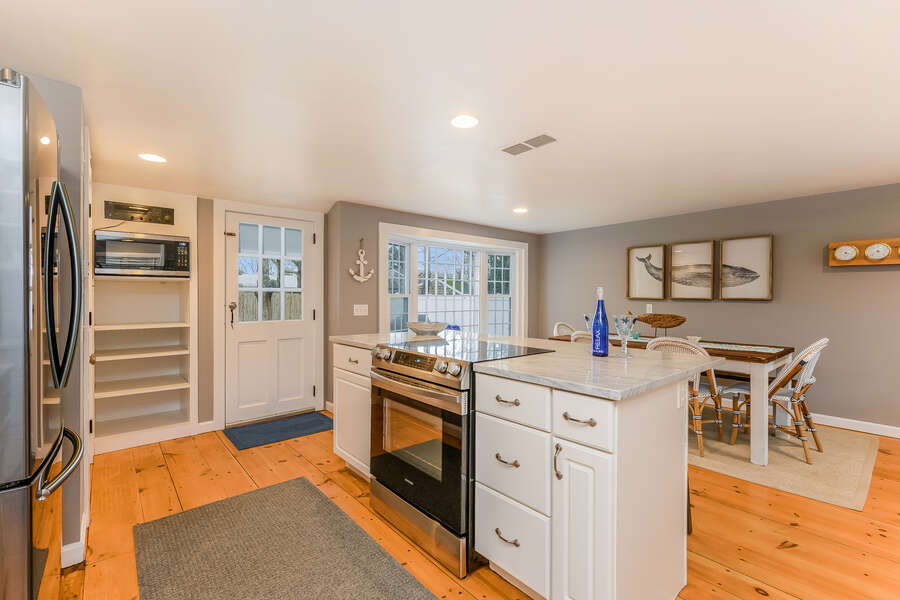 Modern open concept kitchen with entry to back yard-75 Pinewood Rd Hyannis Cape Cod- New England Vacation Rentals