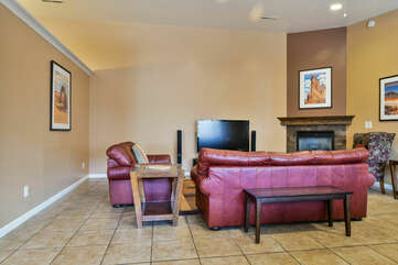 Coffee Table, Sofas, TV, and Fireplace.