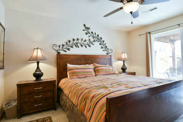 Large Bed, Nightstands, Table Lamps, and Ceiling Fan.