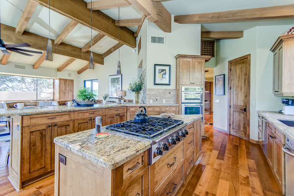 Fully Equipped Chef's Kitchen with Lavish Granite Counters and Custom Cabinetry, and Maple Hardwood Flooring