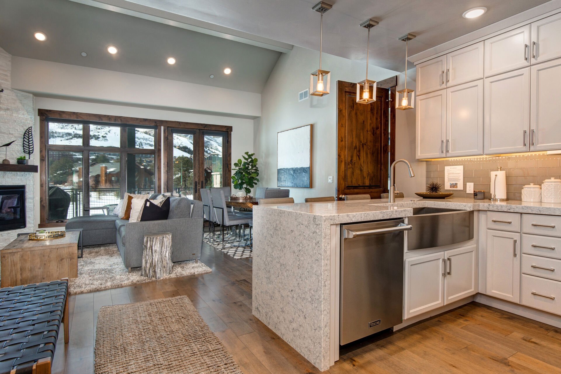 Fully Equipped Gourmet Kitchen with opulent stone countertops, stainless steel Viking appliances, and bar seating for four
