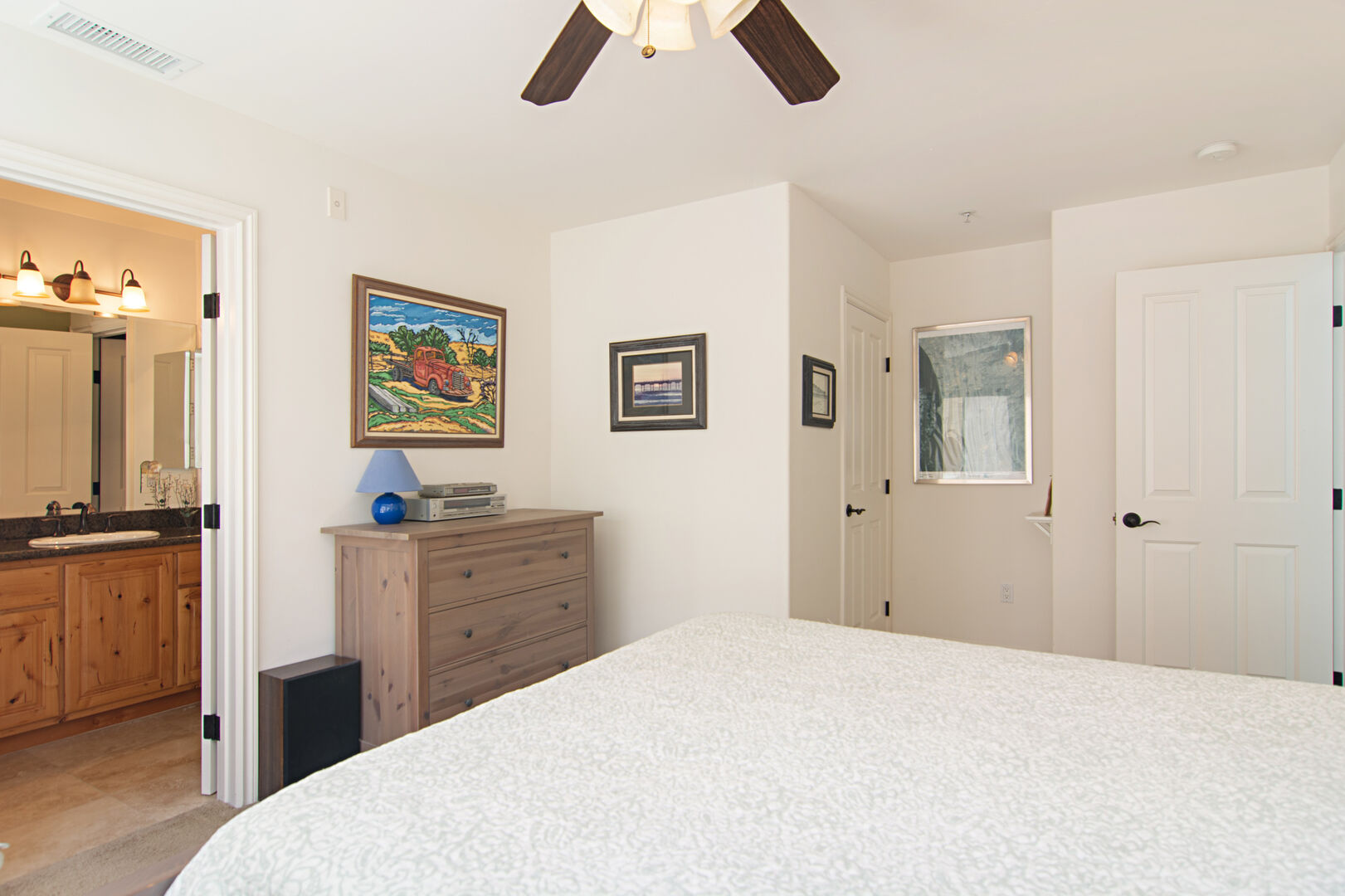 Upstairs master bedroom with queen bed and ceiling fan