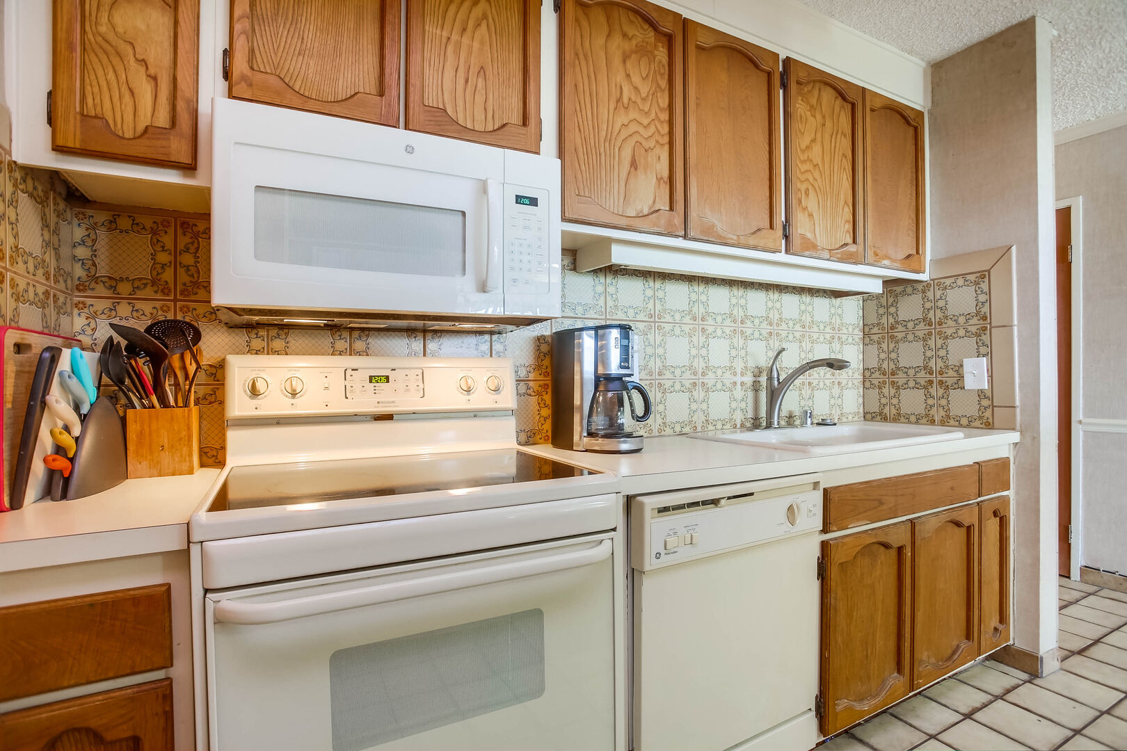 Kitchen appliances include stove, oven, microwave, dishwasher, refrigerator and coffee maker