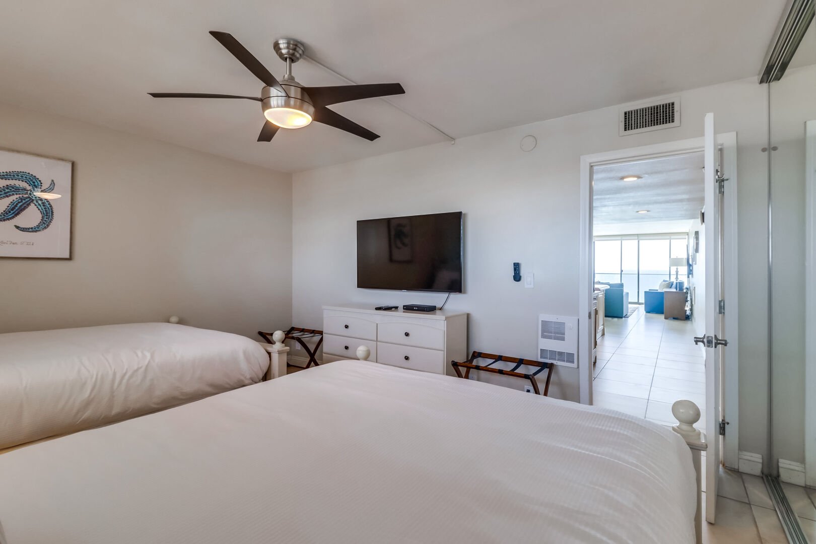 The back bedroom has 2 queen size beds, luggage racks, ceiling fan, star TV and dresser storage