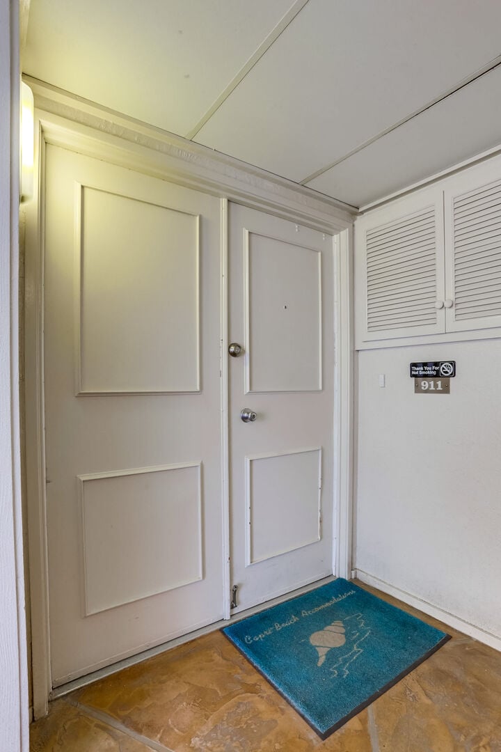 Front door condo entrance with key locks. A fob is needed to enter Capri by the Sea and get up the elevator to the 9th floor.