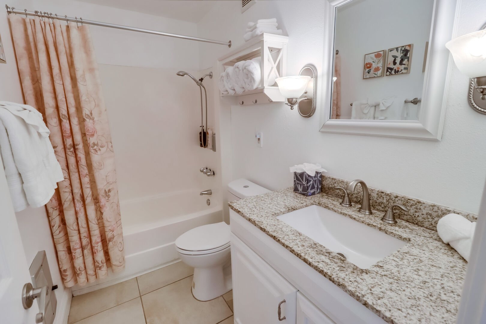 Full shared bathroom with shower-tub combo, hand-held shower head, large vanity with storage, brighting lighting and wall heater