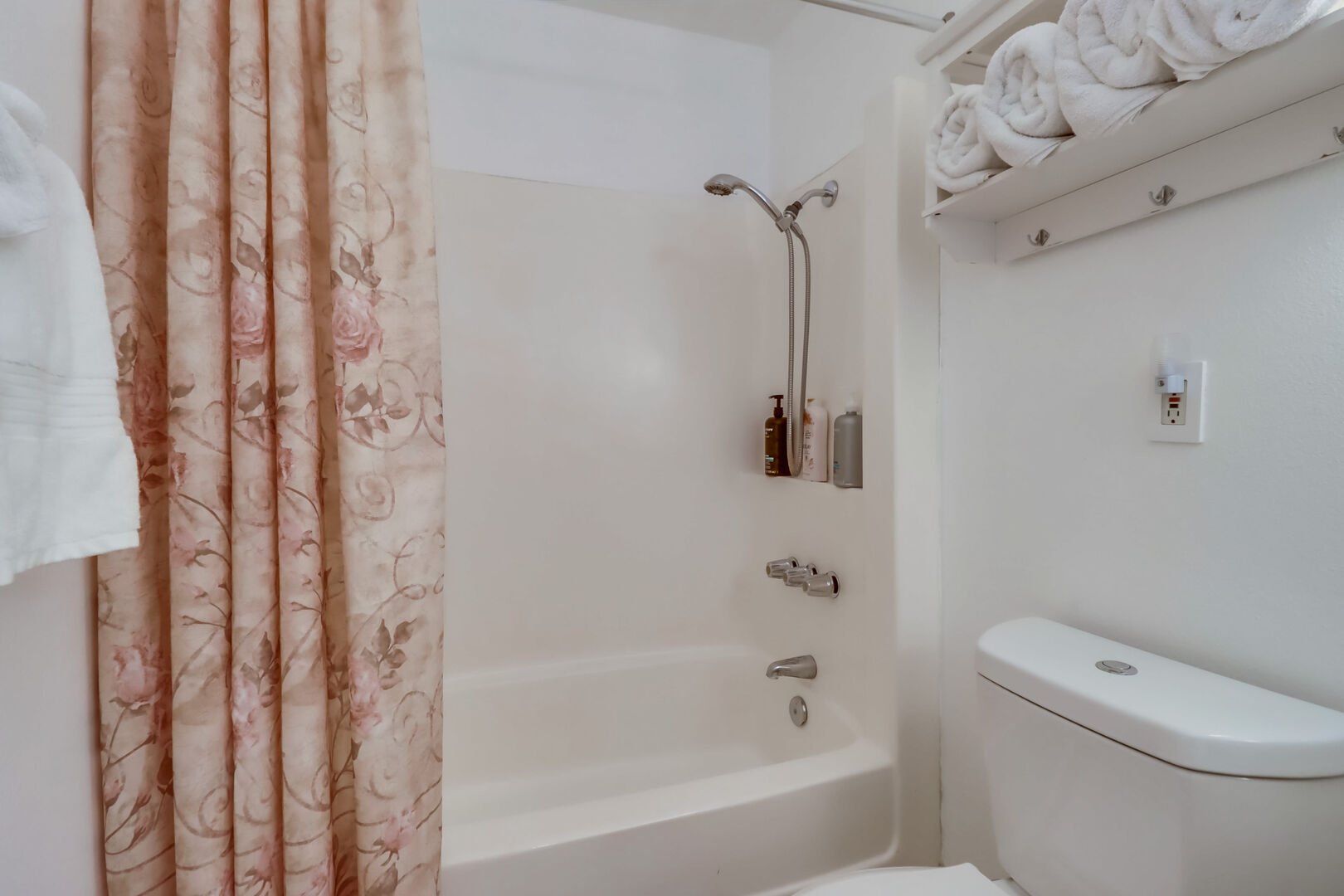 Shared full bathroom has a shower-tub combo with hand-held shower head, large vanity and cabinet storage. All linens and towels, including for the beach are provided!