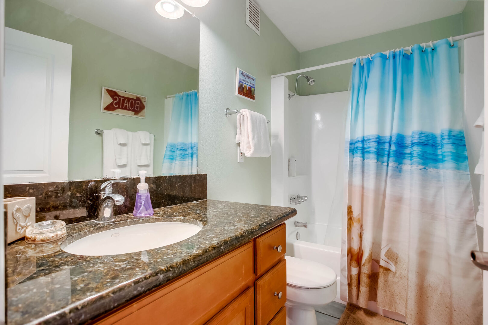 Bathroom with granite countertops, toilet, vanity sink, and tub/ shower combination