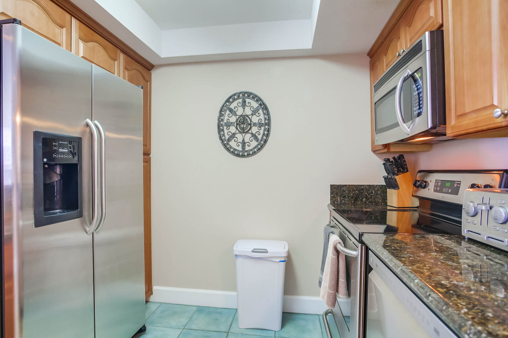 Kitchen with stainless steel appliances, granite countertops, coffee maker, toaster, blender, sink