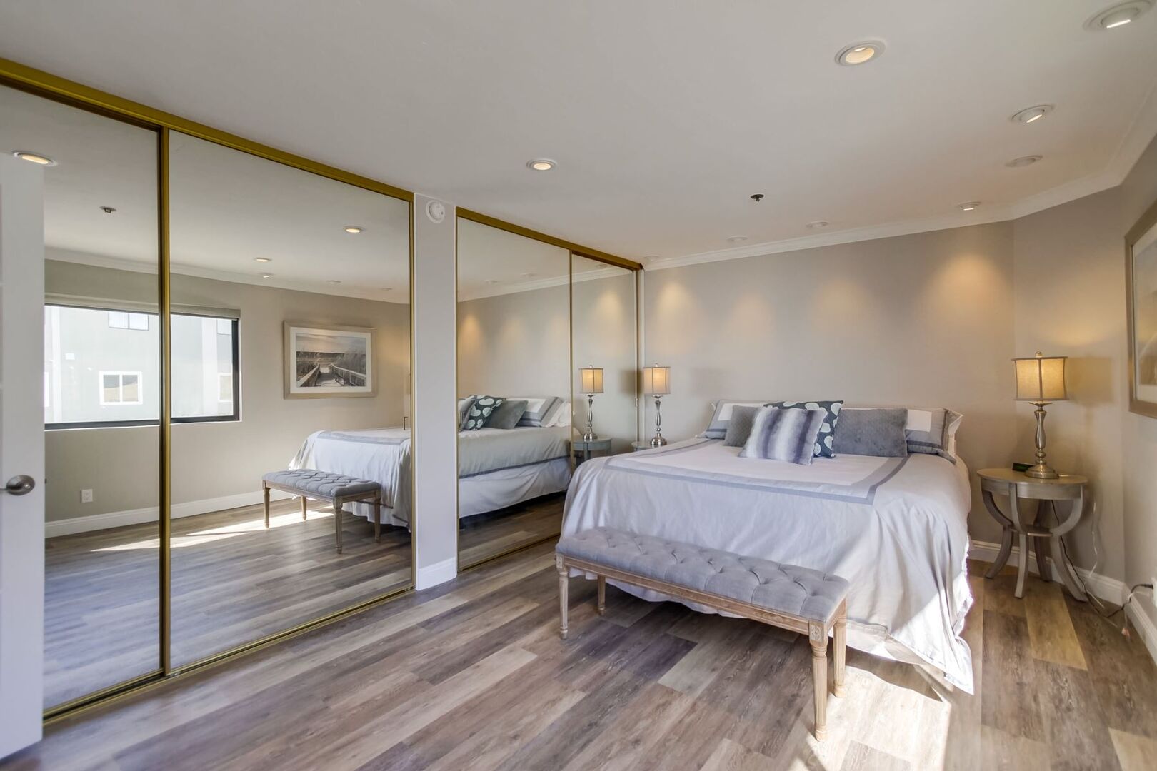 Spacious master bedroom with large mirrored closets