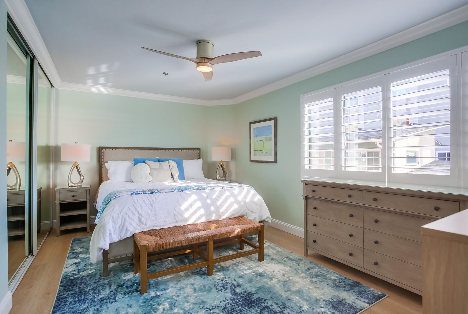 Single bedroom with king bed, overhead lighting and remote-controlled fan, large mirrored closets, all new furniture, flooring, blinds, and decor!