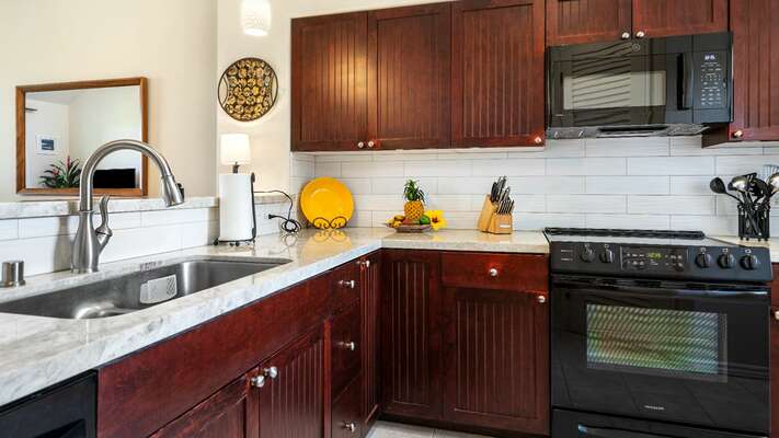 Fully Equipped Kitchen with Black Appliances at Granite Counter Tops