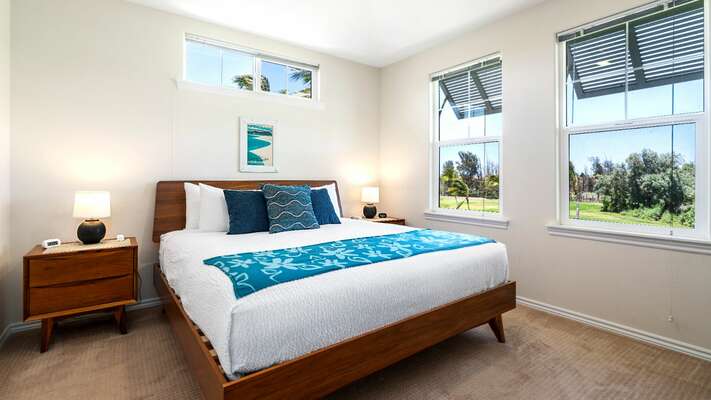 Primary Bedroom with Cozy Decor and Views of Outside at Waikoloa Hawaii Vacation Rentals