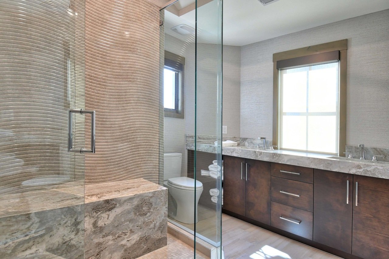 Grand Master En Suite with Dual Stone Counter Sinks and a Large Tile/Glass Shower with Two Shower Heads