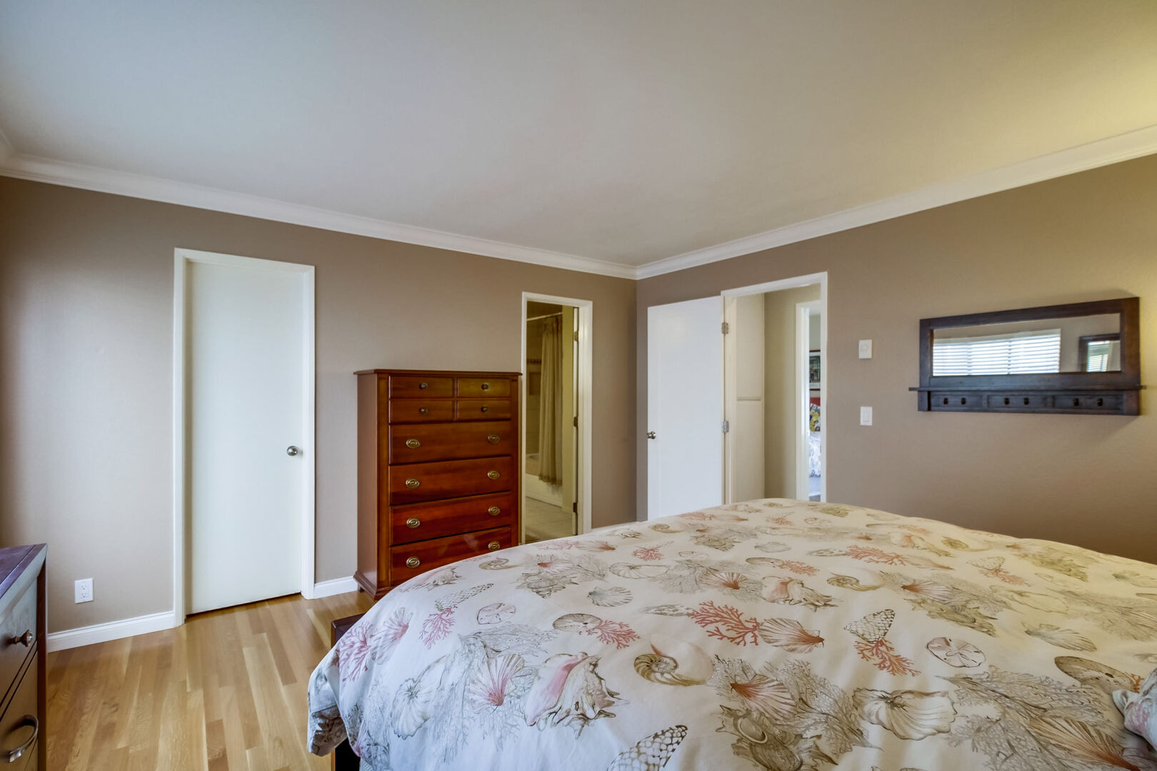 Master bedroom with king size bed, dresser and drawer space, ensuite bathroom and walk-in closet