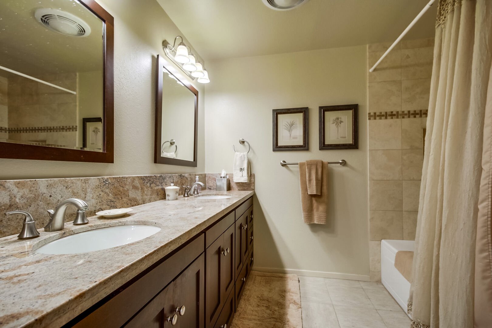 Master bathroom with large dual vanity, recessed light, shower/tub combo, toilet and ample cabinet and drawer space