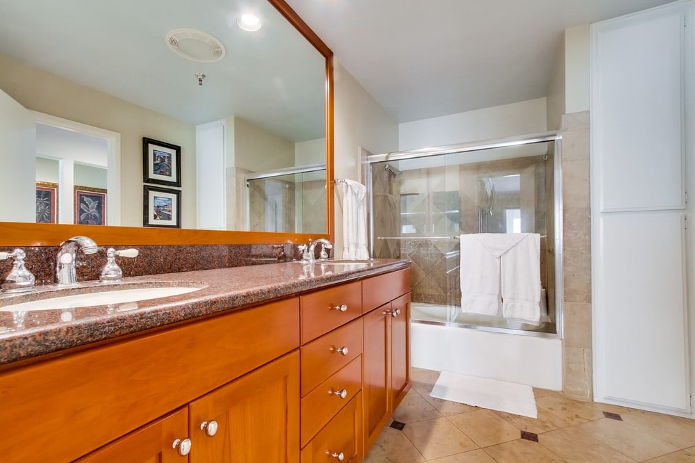 Master bathroom with tub/shower combination, dual vanity, toile  and storage cabinets
