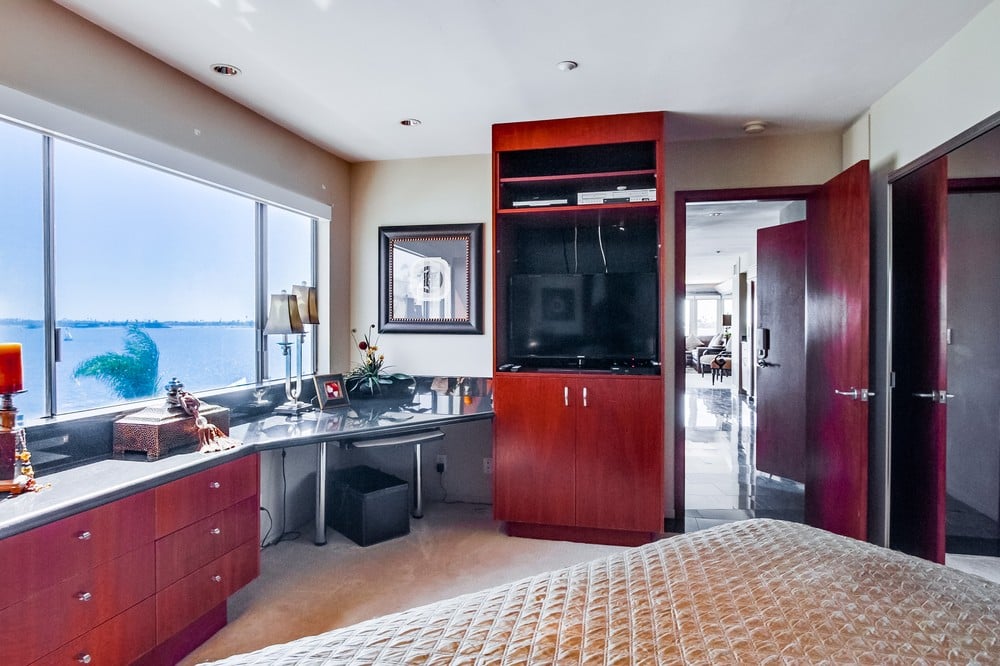 Bedroom with TV, desk area, view of Mission Bay, overhead lighting and ensuite bathroom