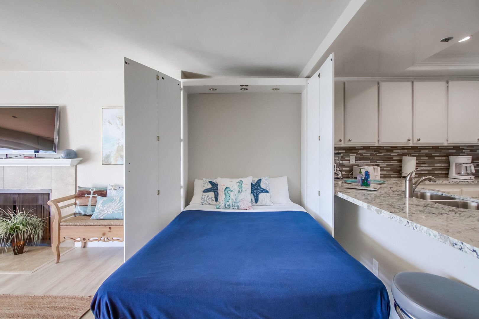 Cozy queen murphy bed in the living room for additional sleeping with the sound of the waves!