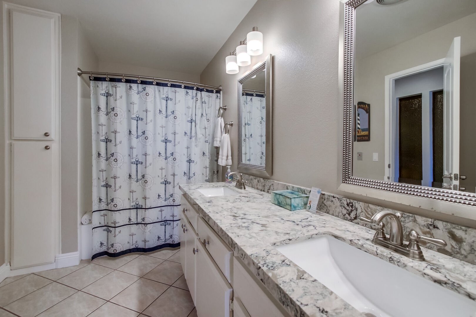 Shared bathroom with shower/ soaking tub, dual vanity, toilet, recessed lighting and storage cabinets