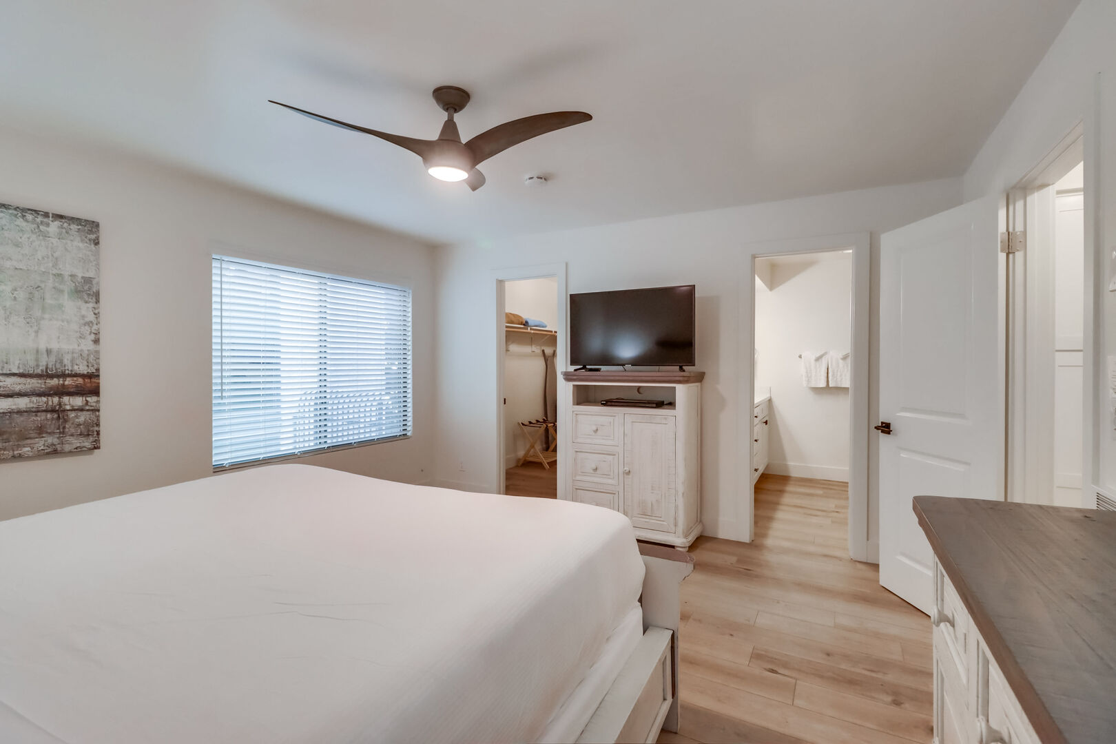 Master with king bed, ceiling fan, smart TV, walk-in closet, dresser and in-suite full bathroom
