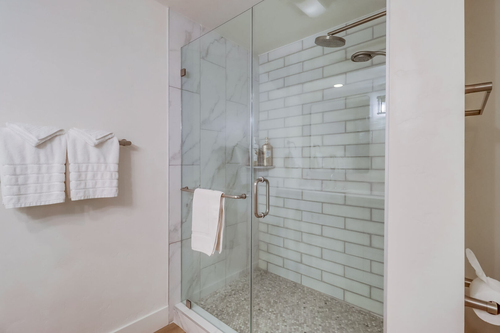 Gorgeous remodeled master bathroom with dual vanity, lighting, and walk-in shower